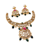 Gold necklace and earrings set with gemstones on a white background