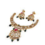 Gold necklace with black and red stones on a white background
