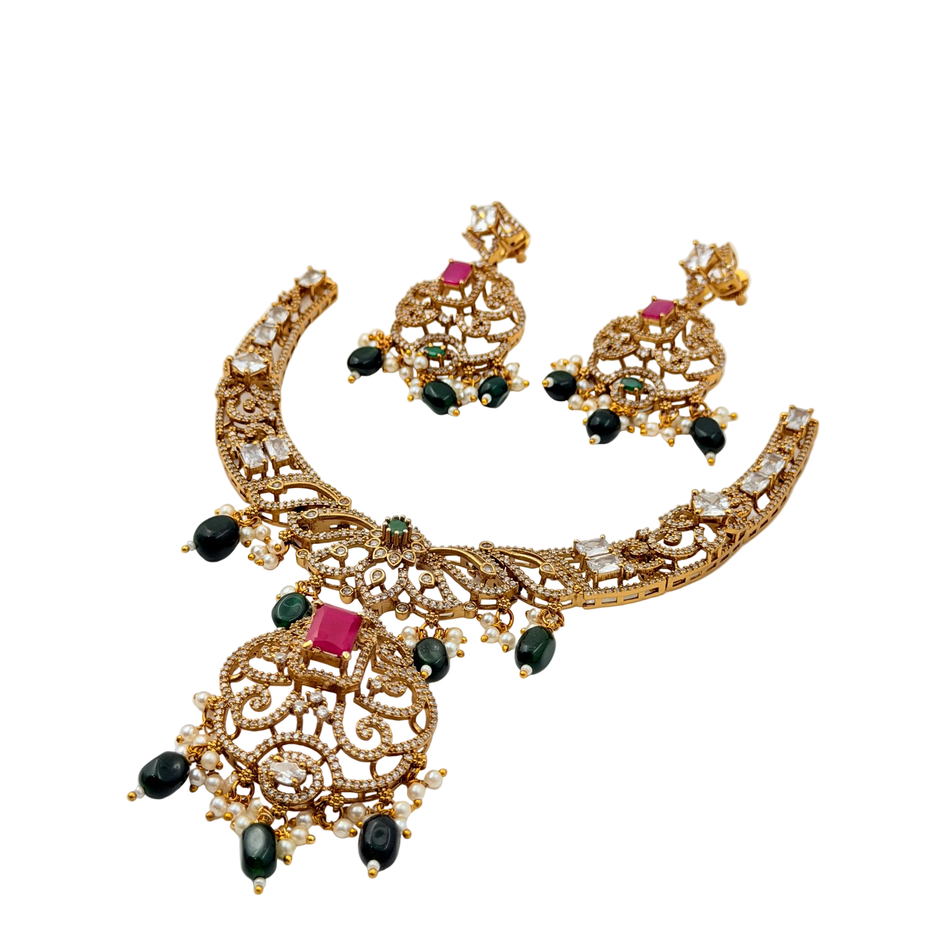 Gold necklace with black and red stones on a white background