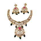 Gold necklace and earrings set with gemstones on a white background