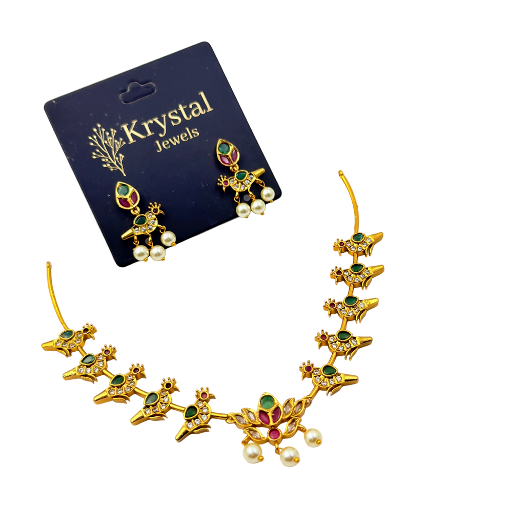Gold necklace and earrings set with gemstones on a Krystal Jewels card.