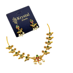 Gold necklace and earrings set with gemstones on a Krystal Jewels card.