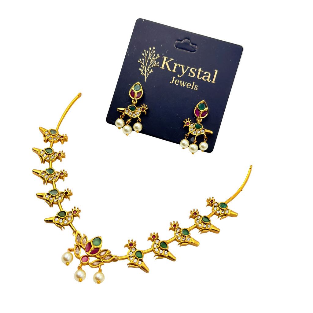 Gold jewelry set with gemstones and pearls on a Krystal Jewels card.