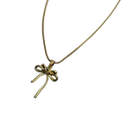 Gold-tone bowknot pendant necklace with clear crystal accent, worn on model's neckline showing chain length