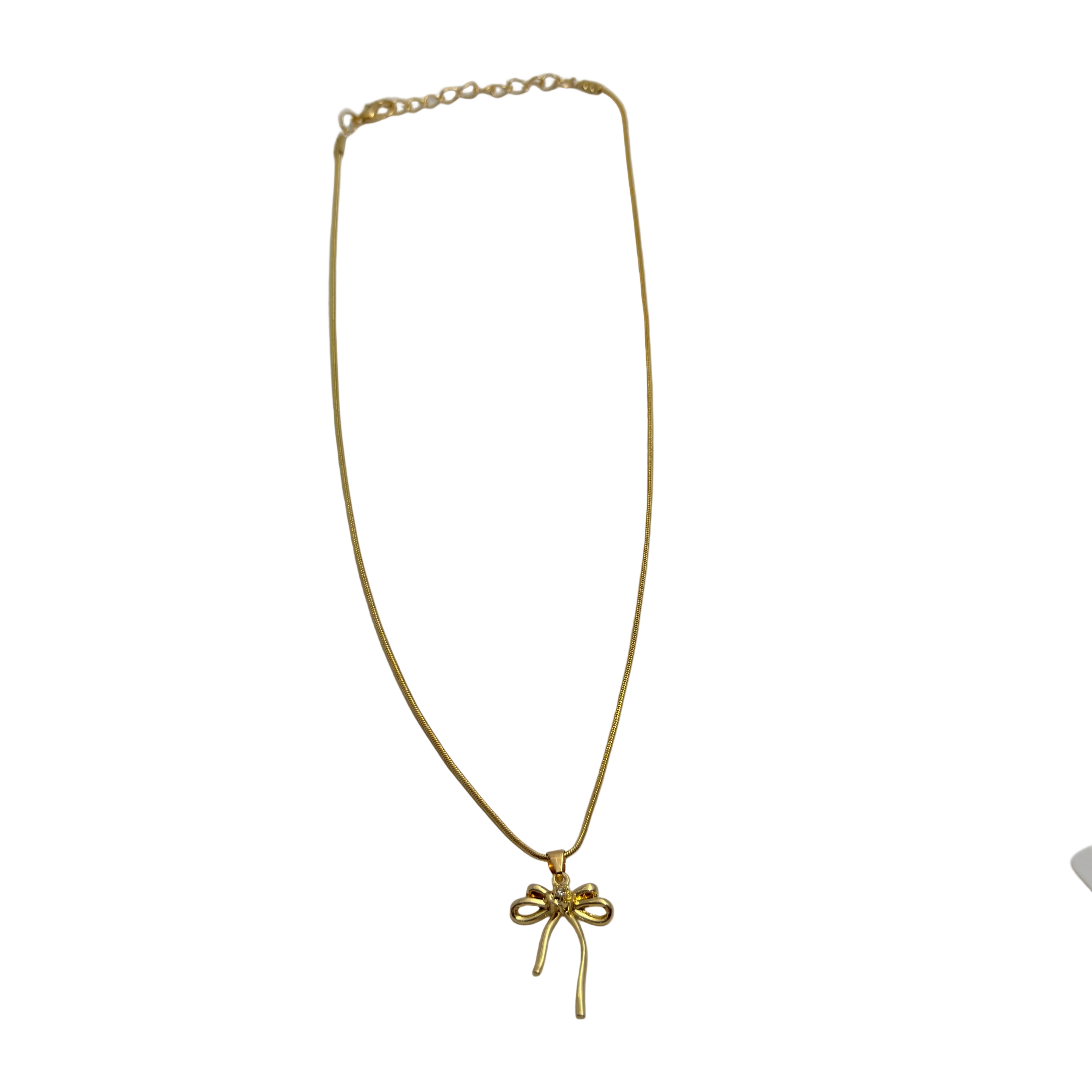 Gold-tone snake chain necklace with bowknot pendant, full flat-lay view showing extendable clasp