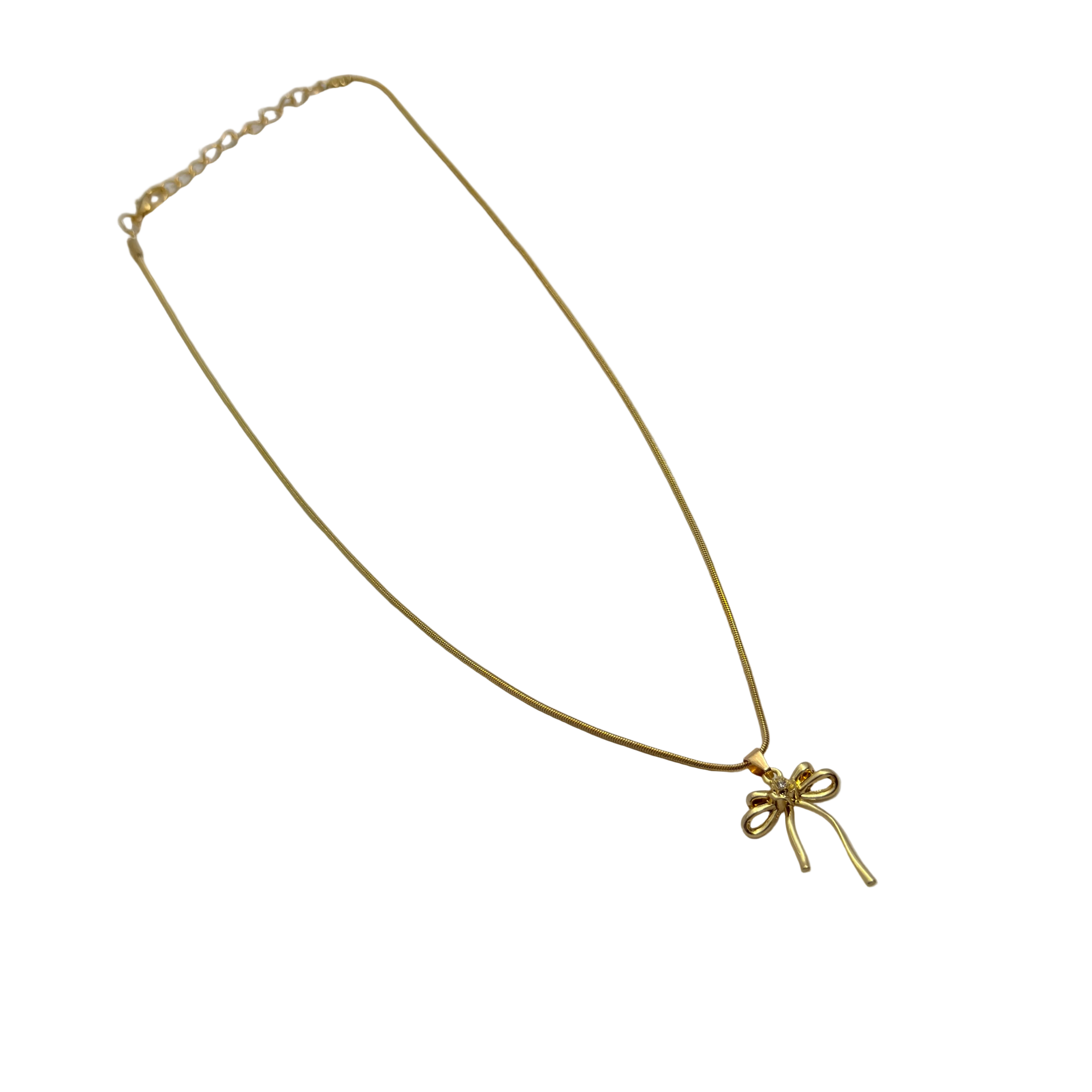 Gold-tone bowknot ribbon pendant with clear crystal center, flat-lay view of chain and clasp
