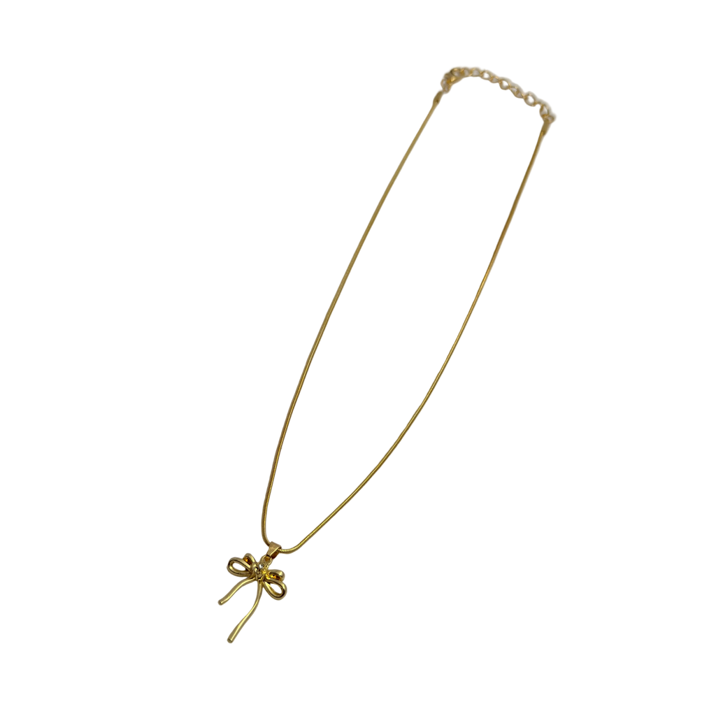 Gold-tone bowknot pendant necklace close-up on white background, full length view