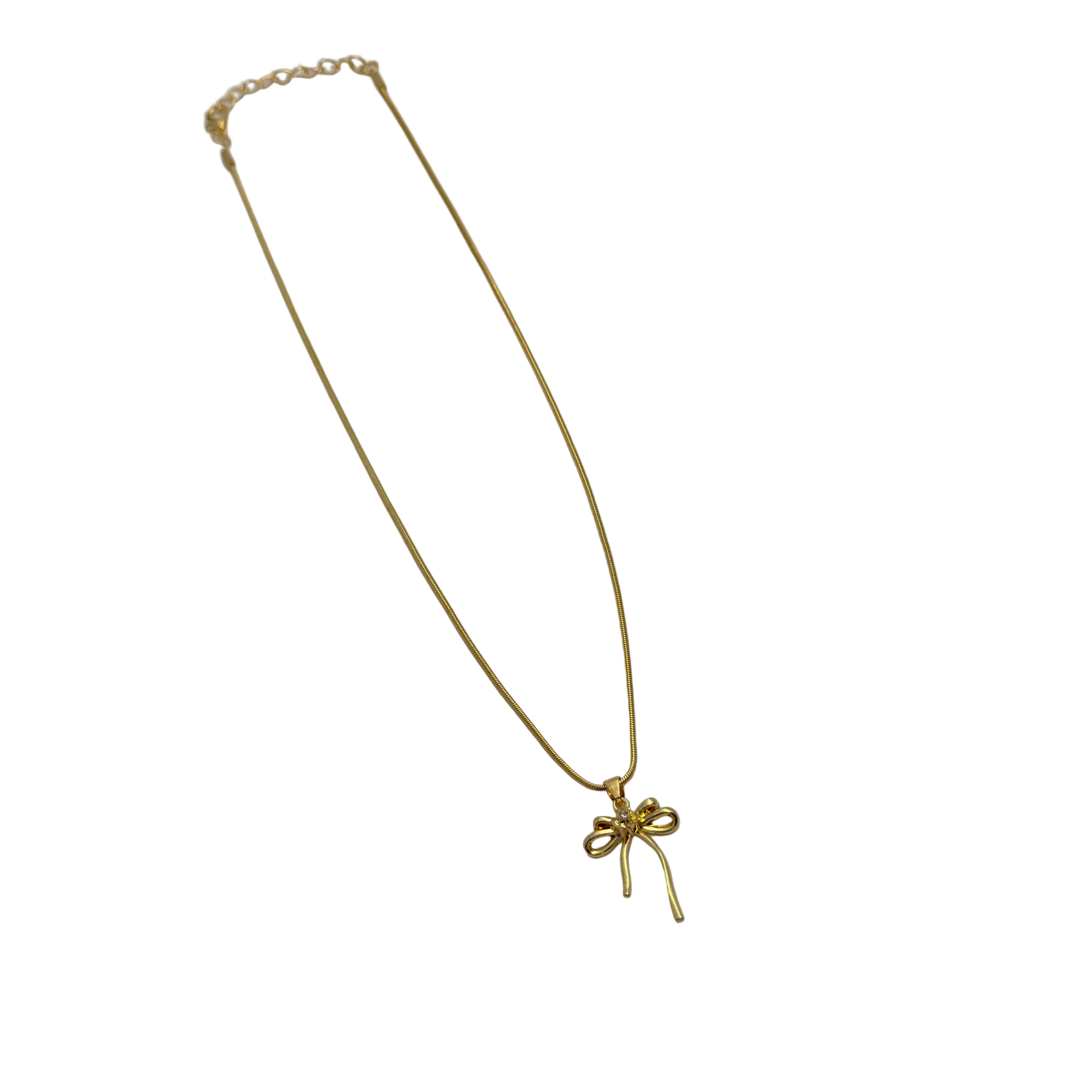 Close-up of gold-tone bowknot ribbon pendant with single round clear crystal center accent