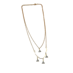Gold-tone double-layered necklace with wavy bar and four trillion-cut crystal charms, flat lay on black background