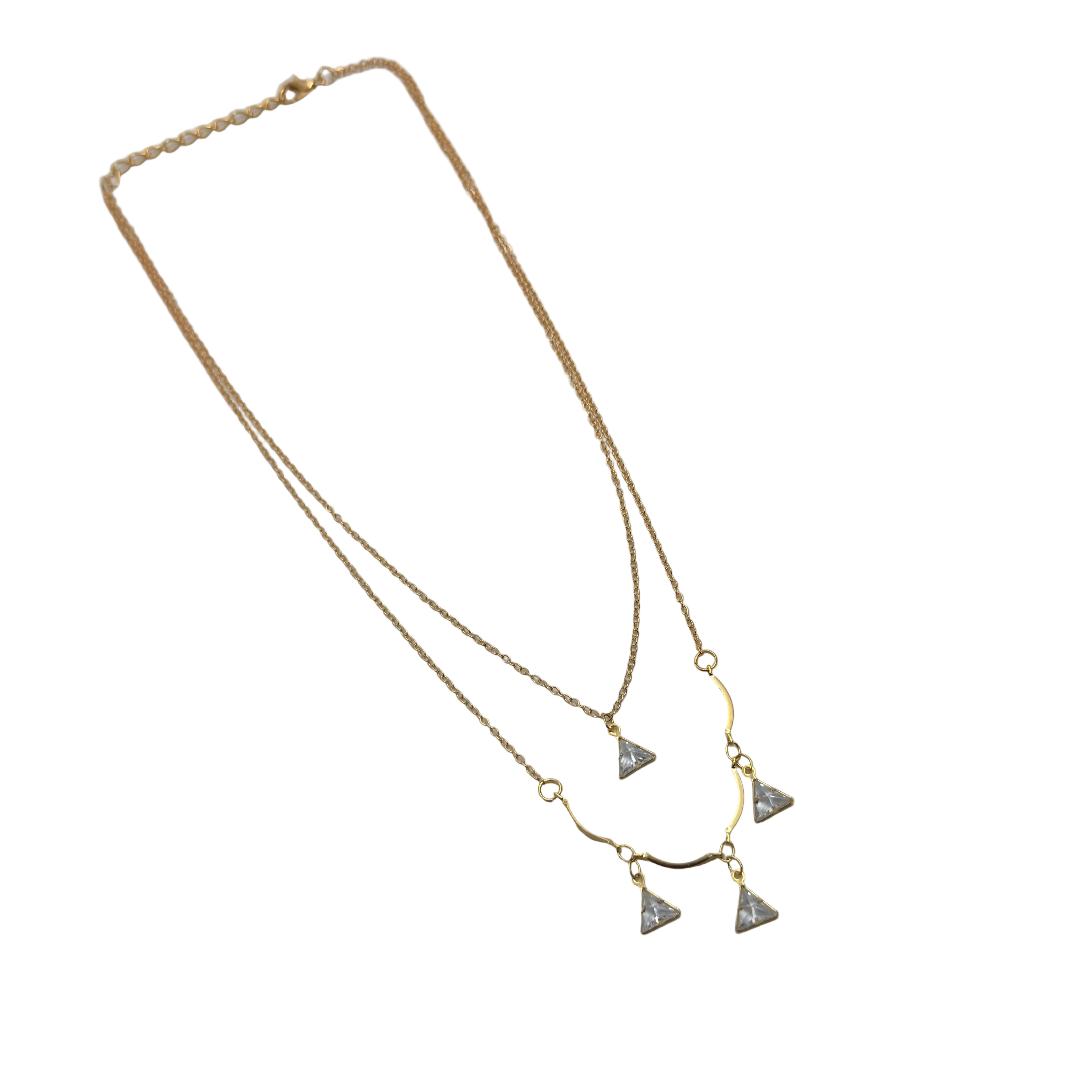 Gold-tone double-layered necklace with wavy bar and four trillion-cut crystal charms, angled flat lay on black background