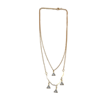 Gold-tone double-layered necklace with wavy bar and four trillion-cut crystal charms, flat lay on white background