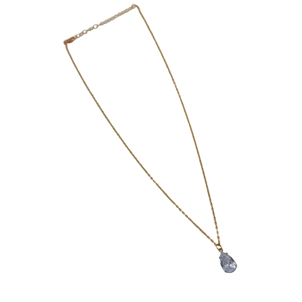 Gold-tone pendant necklace with pear-cut clear crystal solitaire, full flat-lay view