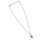 Gold-tone pendant necklace with pear-cut clear crystal solitaire, full flat-lay view