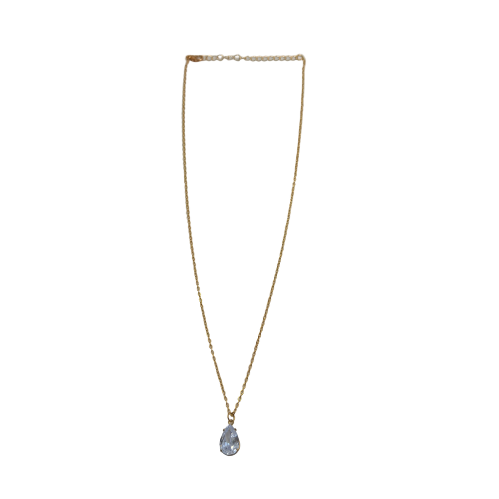 Gold-tone pendant necklace with pear-cut clear crystal solitaire, full flat-lay view