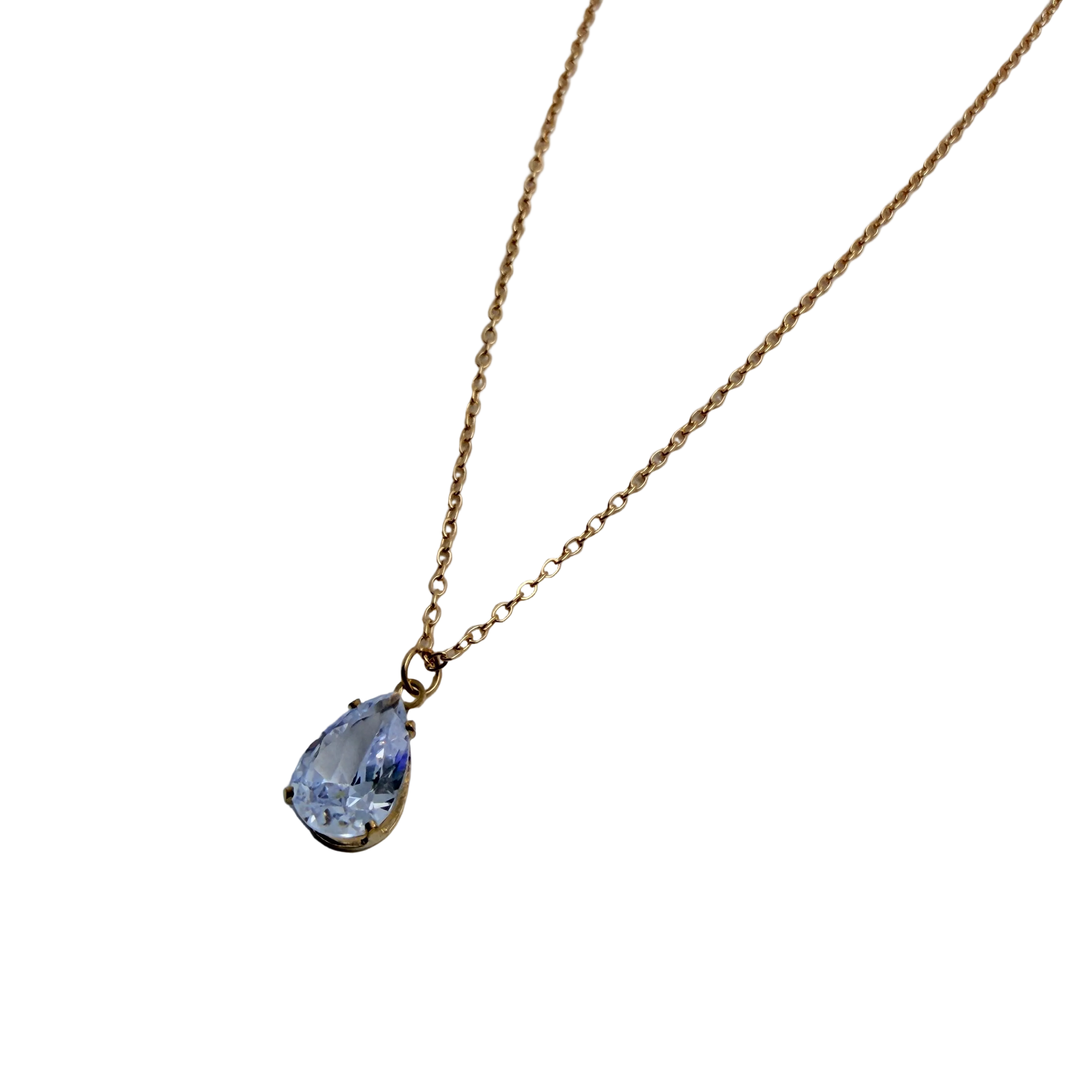 Gold-tone pendant necklace with pear-cut clear crystal solitaire, close-up on the multi-prong pendant setting