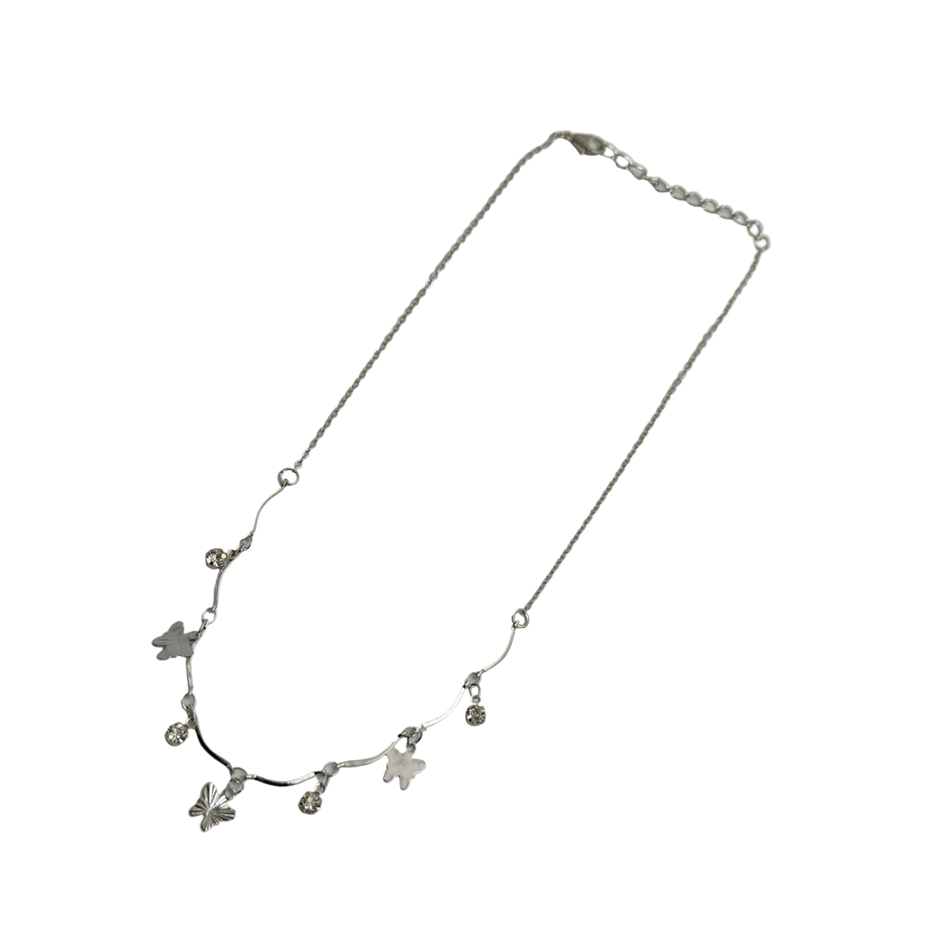 Polished silver butterfly charm necklace with wavy bar and crystal accents, full flat-lay view