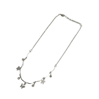 Polished silver butterfly charm necklace with wavy bar and crystal accents, full flat-lay view