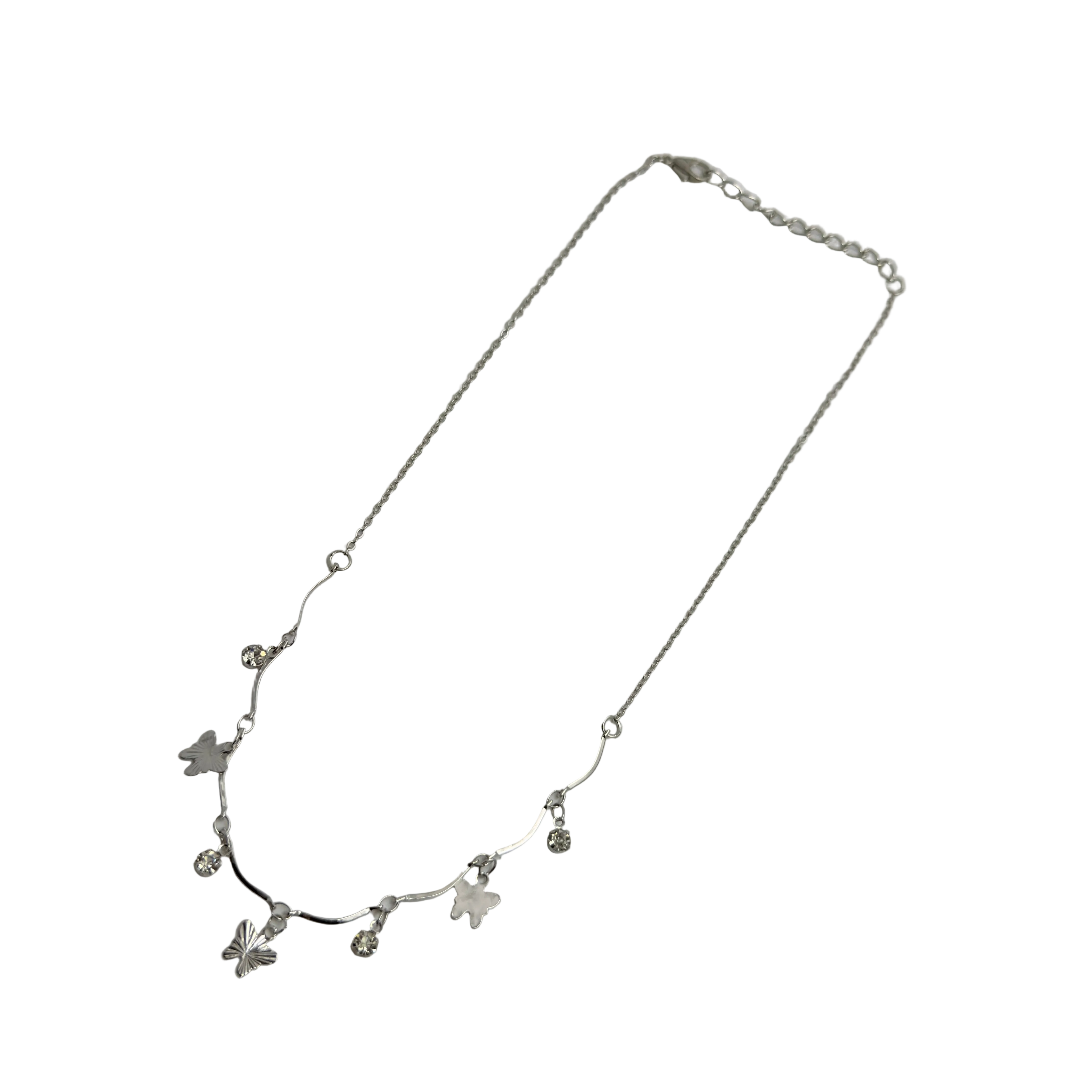 Polished silver butterfly charm necklace with wavy bar and crystal accents, full flat-lay view