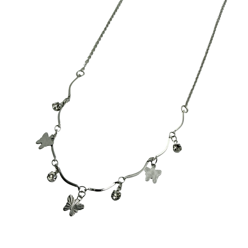 Polished silver butterfly charm necklace with wavy bar and crystal accents, close-up detail on black background