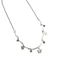 Polished silver butterfly charm necklace with wavy bar and crystal accents, close-up flat-lay detail