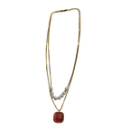 Gold-tone layered necklace with pearls and carnelian pendant, full flat-lay view on white background