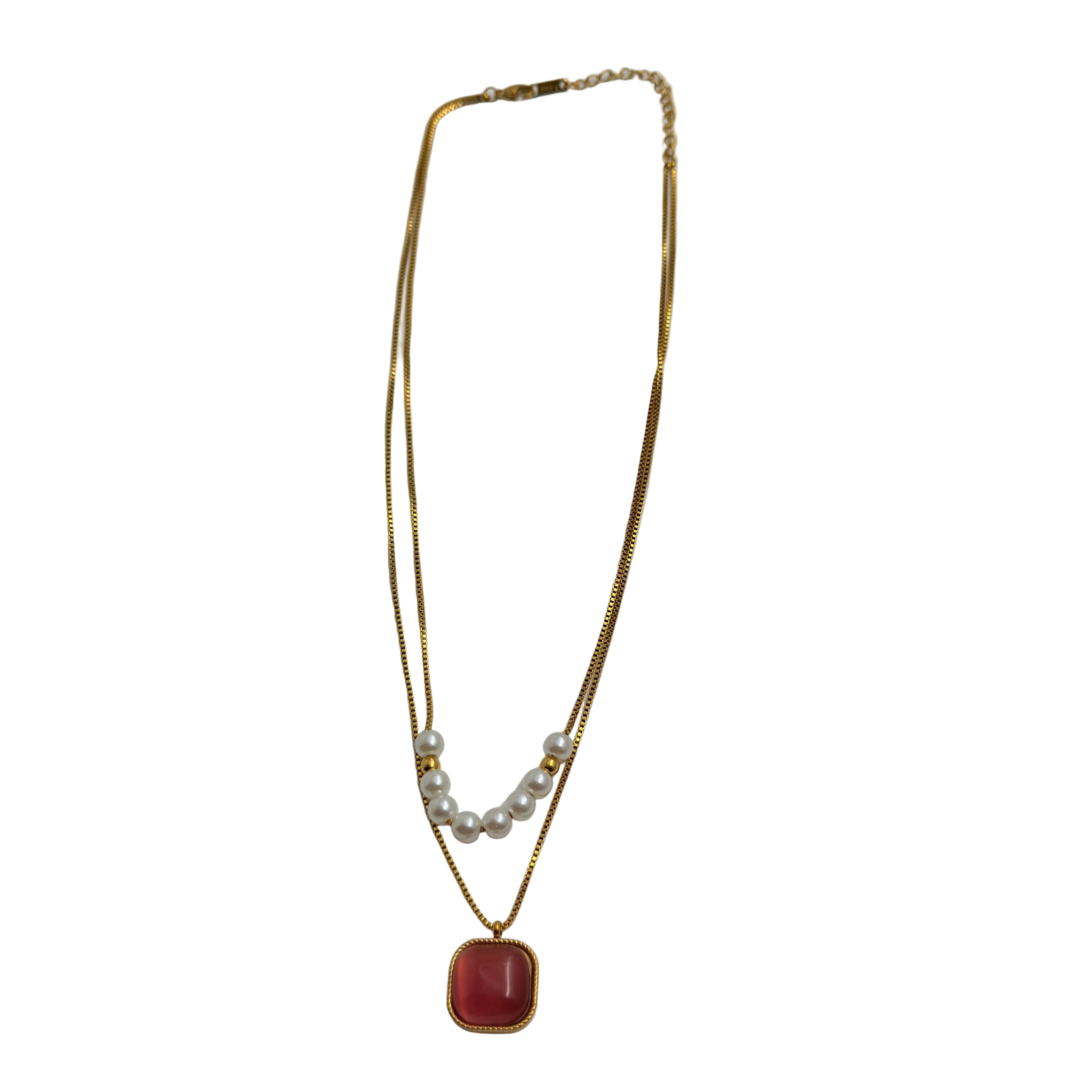 Gold-tone layered necklace with pearls and carnelian pendant, full flat-lay view on white background