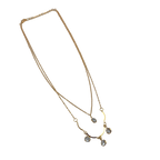 Gold-tone double-layer necklace with clear crystal charms, flat lay showing full chain length