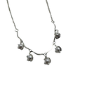Silver-tone pearl charm necklace with wavy collar bar, worn on neck at the beach