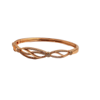 Rose gold-tone bangle bracelet with pave crystal split-helix design, close-up of hinge and crystal cluster detail