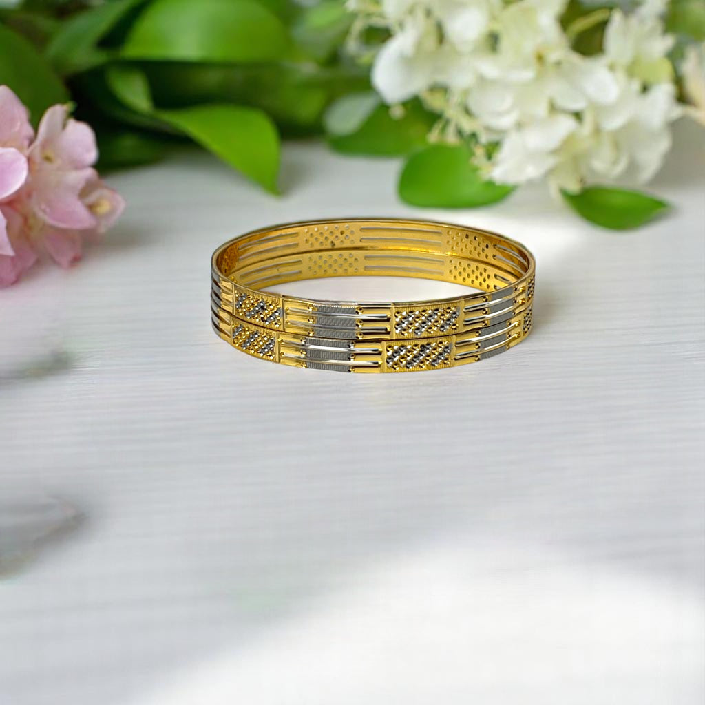 Gold two-tone bangle set with CZ-studded panels, worn on a wet wrist poolside