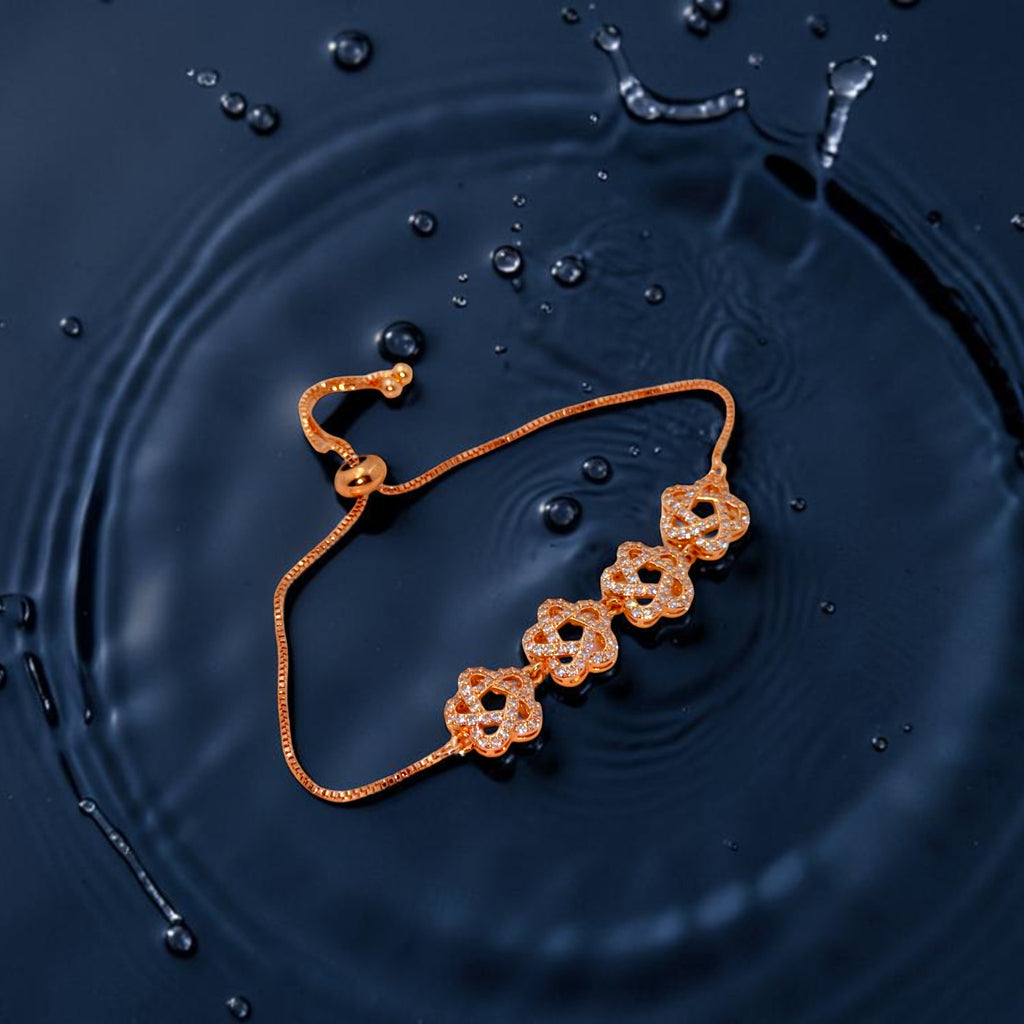 Rose gold floral chain bracelet with crystal accents and adjustable slider, worn on wrist