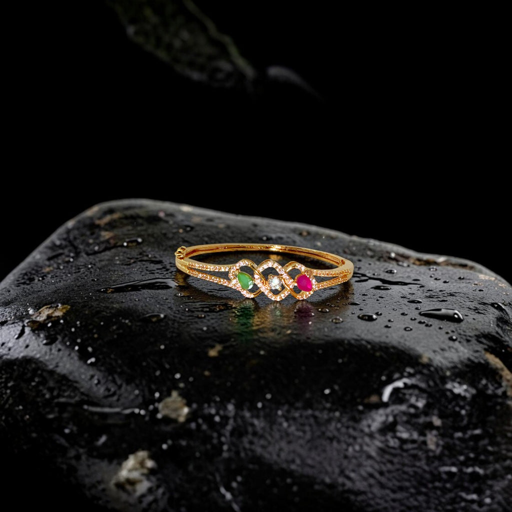 Gold ring with gemstones on a dark textured surface