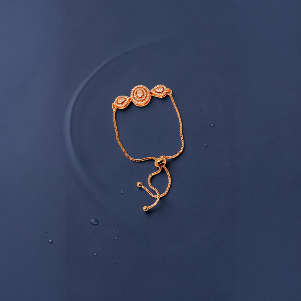 Rose gold crystal bracelet with adjustable slider chain, worn on wrist showing central circular crystal cluster