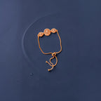 Rose gold crystal bracelet with adjustable slider chain, worn on wrist showing central circular crystal cluster
