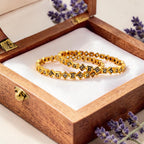 Gold square-cut crystal bangle set worn on wrist by pool, showing waterproof shine