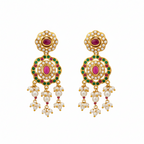 Gold Kundan drop earrings with pearl clusters, worn on ear showing floral design