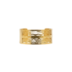 Gold wave cuff bracelet with heart motif detailing, front view close-up