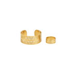 Gold wave cuff bracelet and open ring set with heart motif, angled flat lay