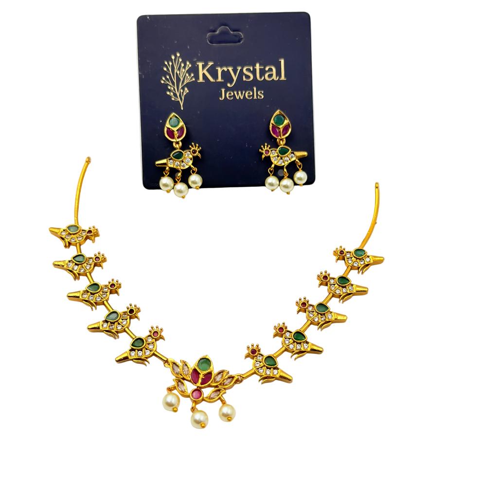 Gold necklace with green and red stones on a Krystal Jewels card