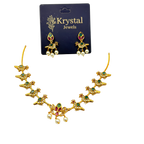 Gold necklace with green and red stones on a Krystal Jewels card