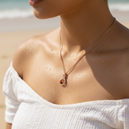 Rose gold swan crystal pendant necklace with delicate box chain, worn on-model at the beach showing wearable length