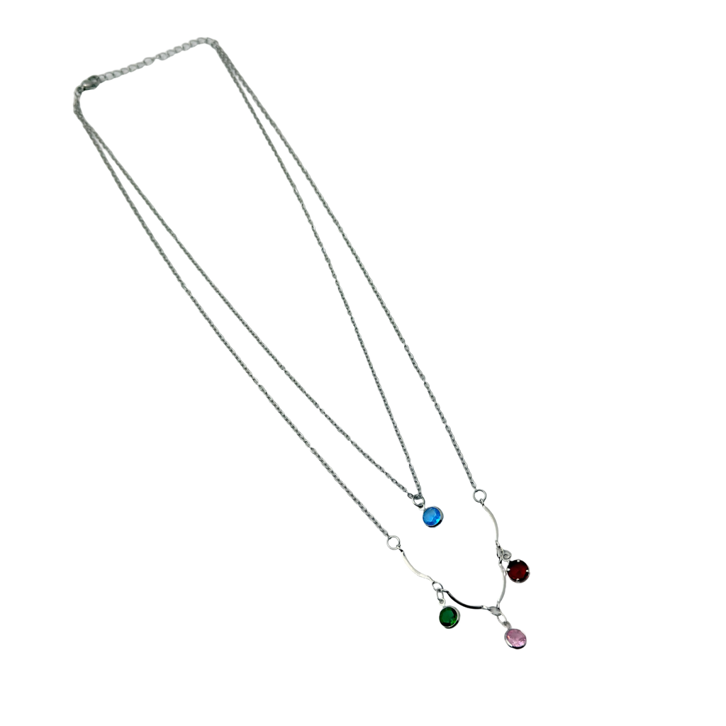 Silver-tone layered necklace with blue, green, red and pink crystal charms, full flat-lay view