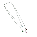 Silver-tone layered necklace with blue, green, red and pink crystal charms, full flat-lay view