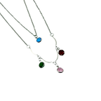 Silver-tone layered necklace, close-up of multicolor crystal charm details