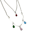Silver-tone layered necklace with pastel teardrop crystal charms, close-up detail of chain and charm drops
