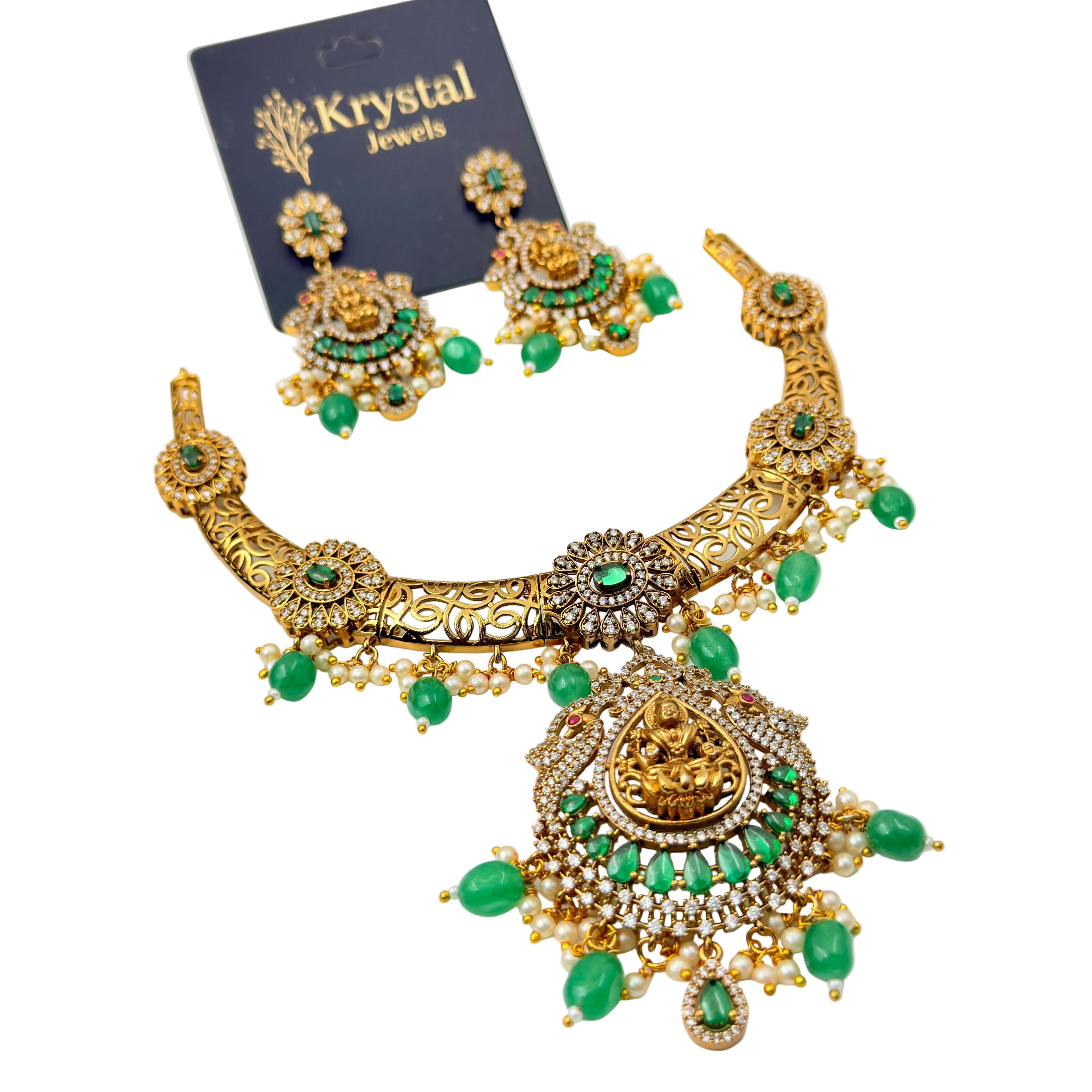 Gold and green jewelry set with 'Krystal Jewels' card on a white background