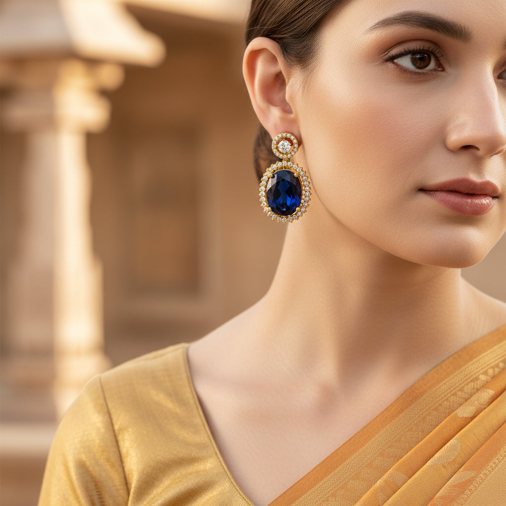 Pair of earrings with dark gemstones and gold accents