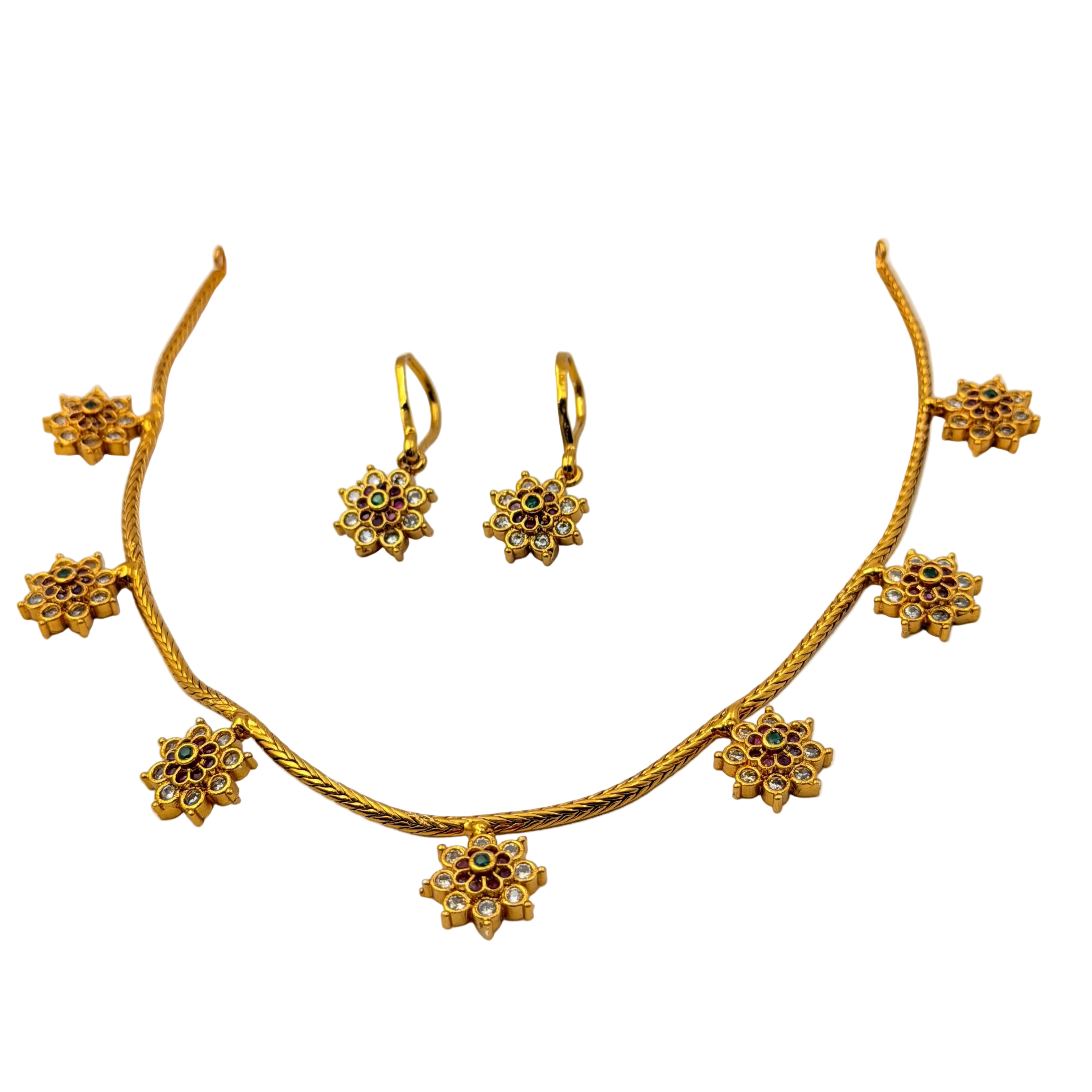 Gold necklace and earrings set on a white background