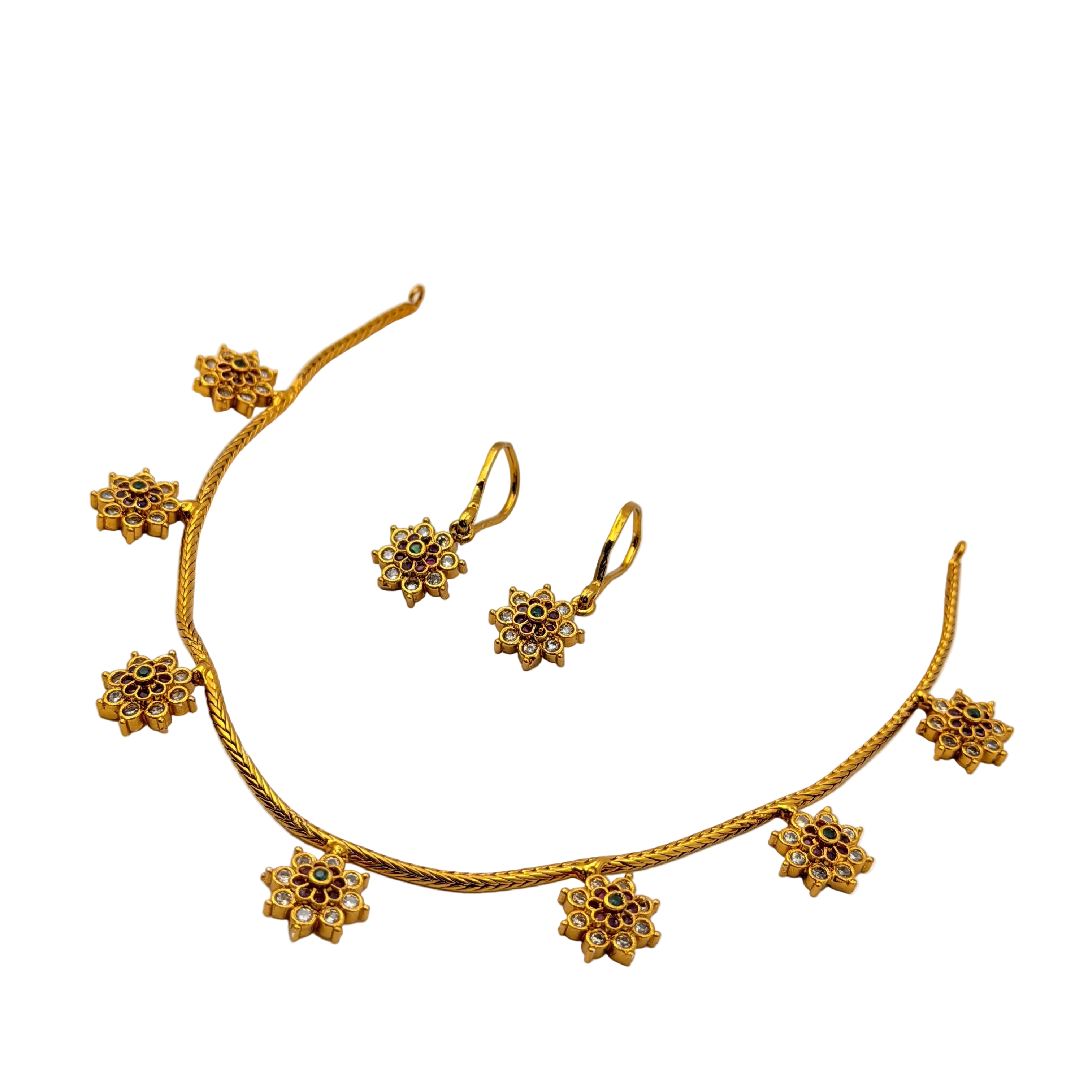Gold necklace and earrings set on a white background