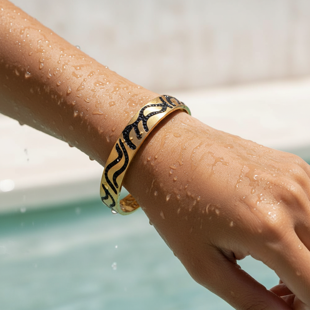 Hand wearing a patterned bracelet by a pool